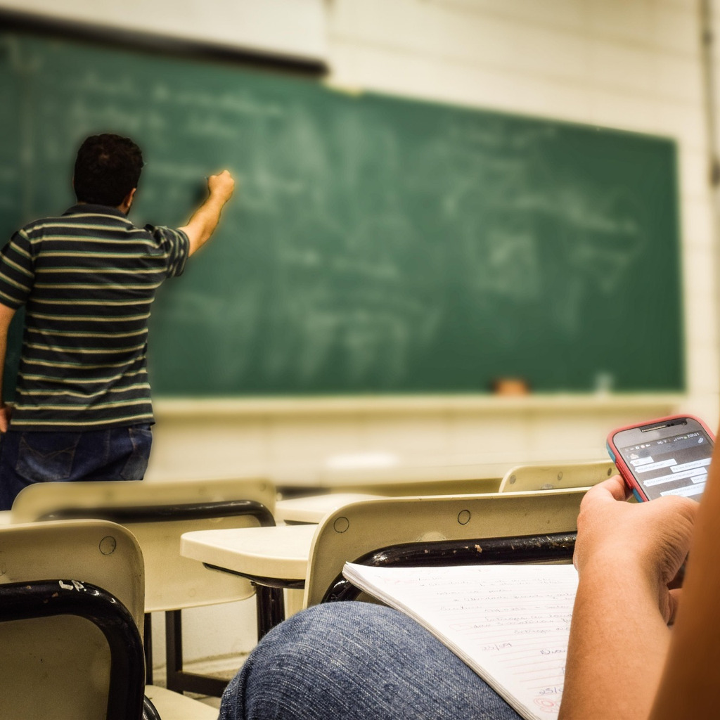 Student using smartphone in classroom